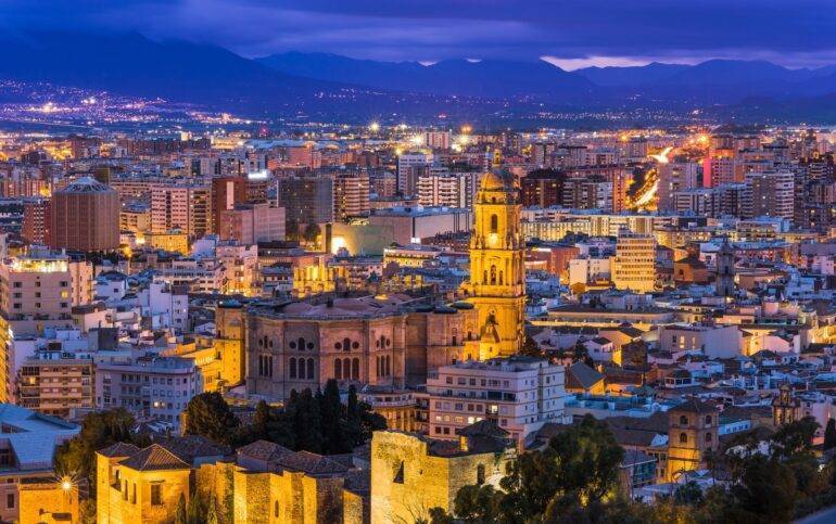 Discover the exciting nightlife of Malaga on the Costa del Sol. Malaga cathedral and cityscape at twilight