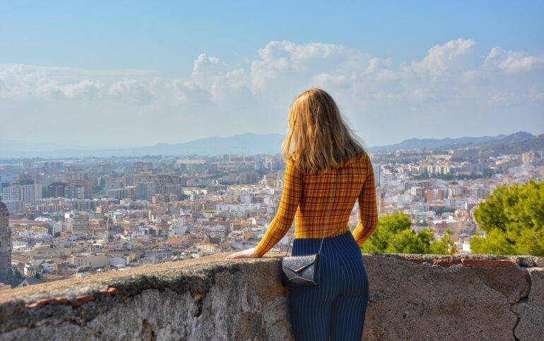 The Best Villages in Málaga for a Summer Getaway. Girl watching view over Malaga,Spain