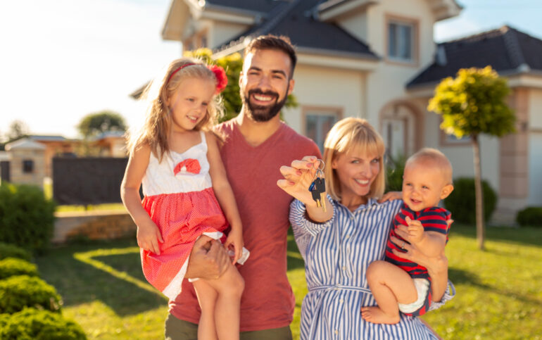 Buying a House in Spain: Essential Steps to Start Your Adventure. Family holding keys after buying house