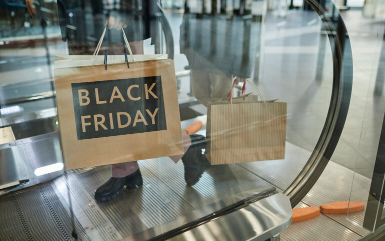 Black Friday in Marbella: Unique Opportunities for Shopping. Woman Holding Black Friday Shopping Bags